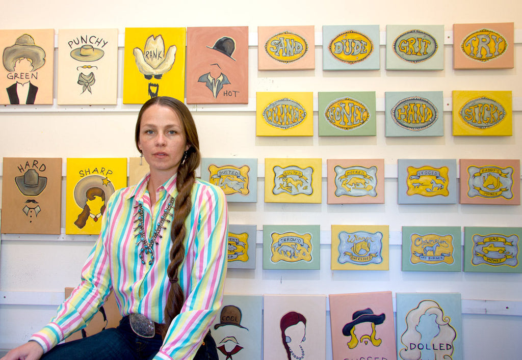 Western artist Gina Teichert in front of her Cowboyology painting series