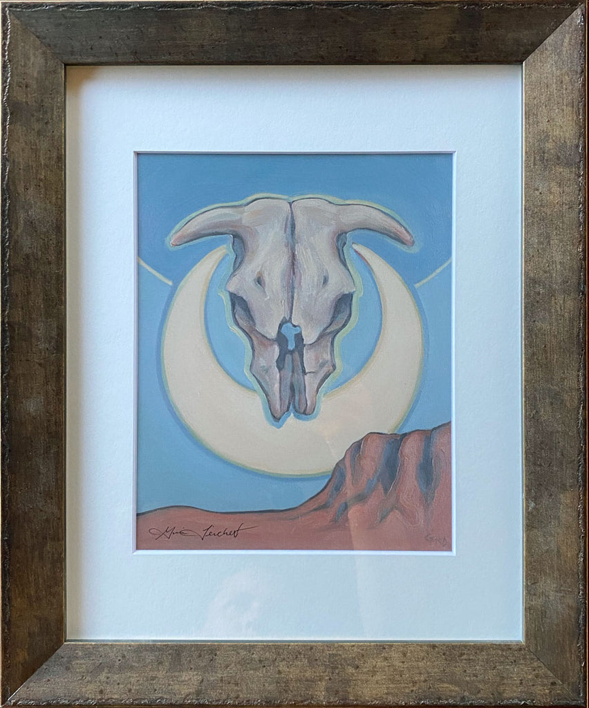 Print of a skull and cresent moon in a metallic frame