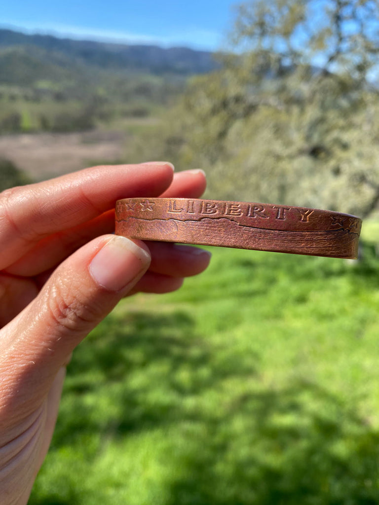 Solid copper bracelet with Liberty stamped on front