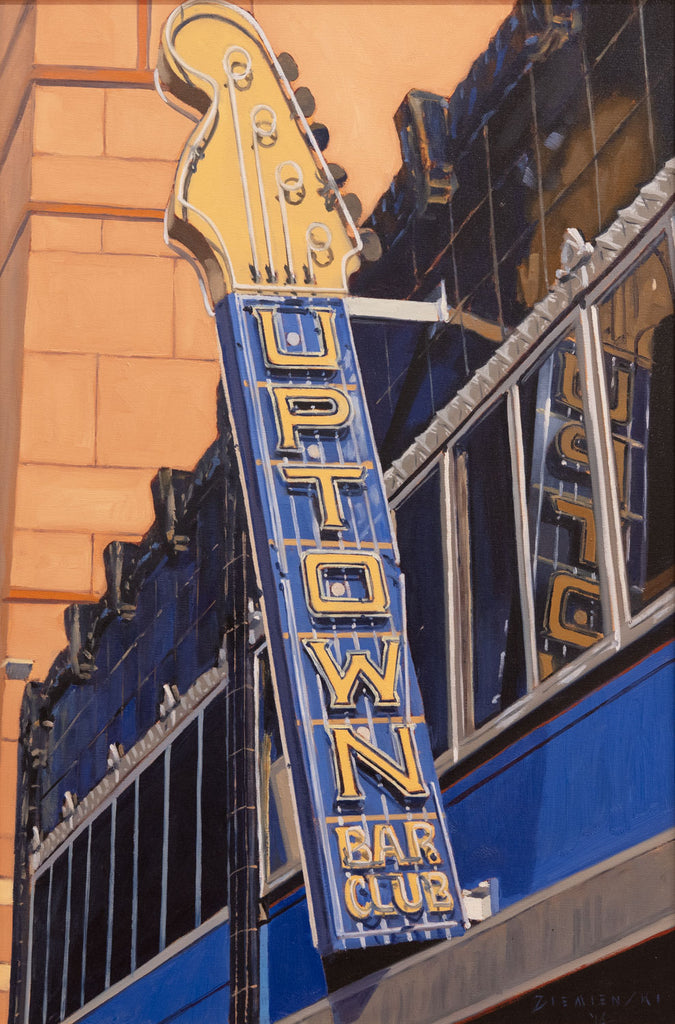 Neon sign for Uptown Bar Club on a building facade
