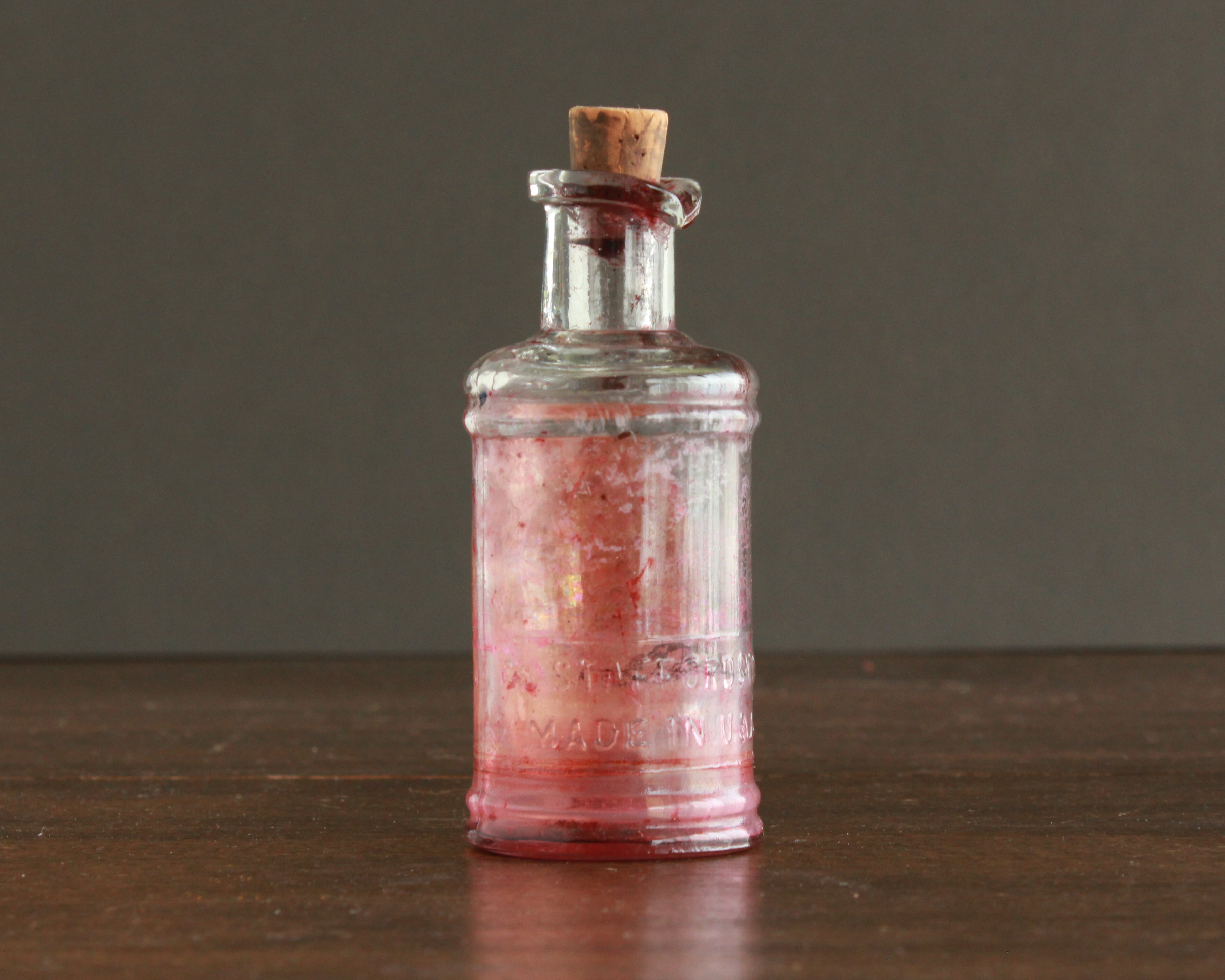 antique ink bottle with paper label and cork