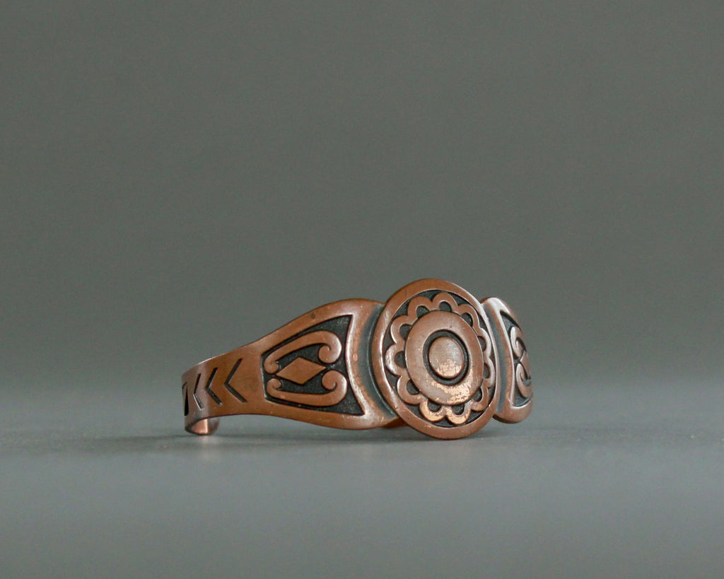 Vintage copper cuff with geometric overlay design 