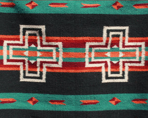 Green and black Southwest print wool rug with white crosses