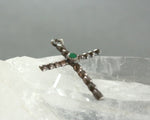 silver cross pendant with green stone 