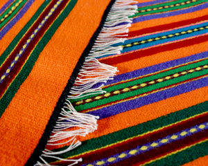 Handwoven Mexican table runner in orange stripe