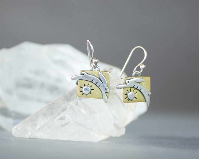 Rabbit jumping over the sun earrings, silver and brass