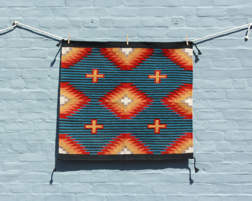 Hand woven southwest print saddle blanket in blue and orange