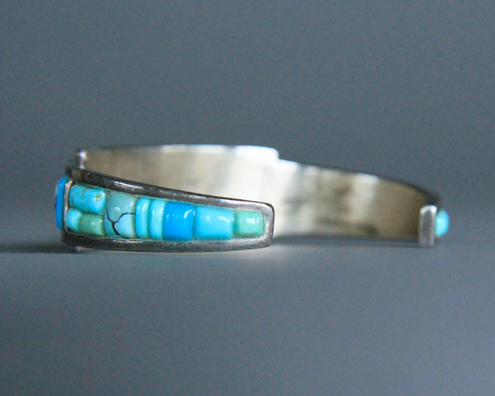 Back of a turquoise and silver colored cuff