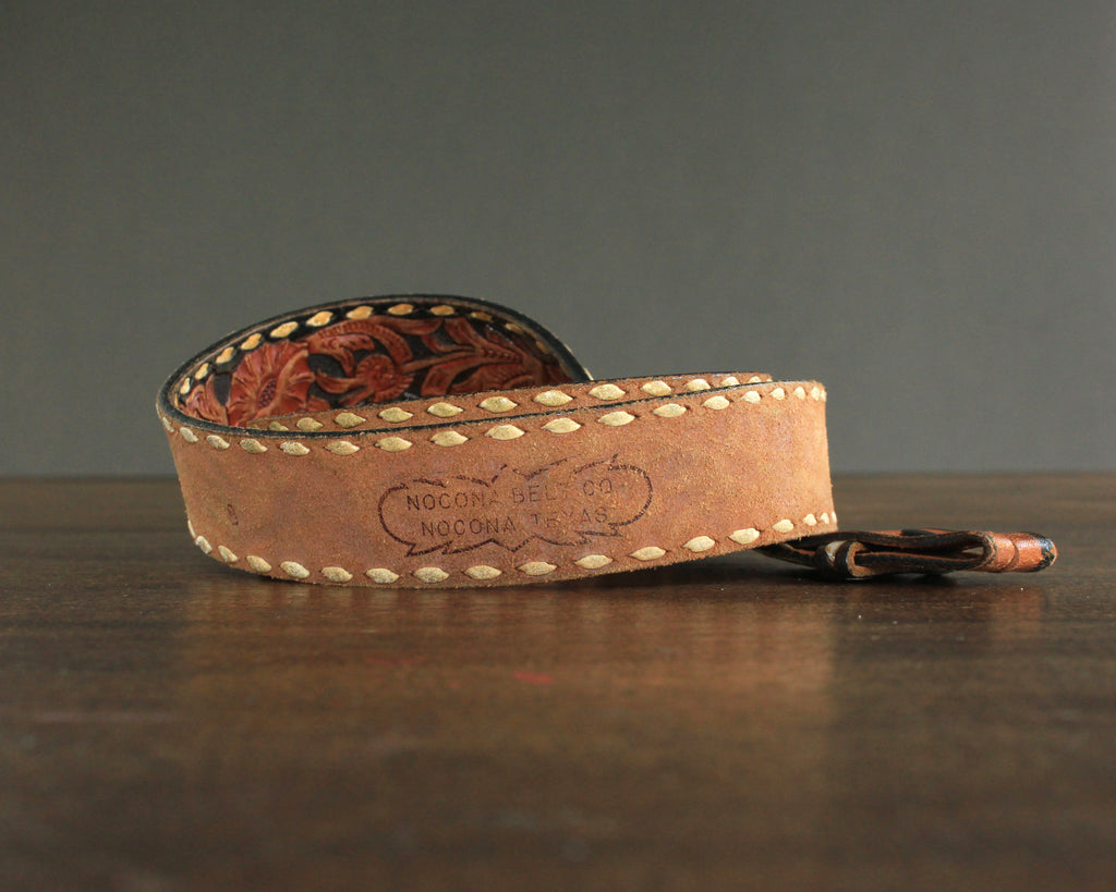Vintage tooled leather belt with white lacing and floral pattern 