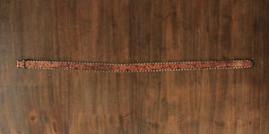 Vintage tooled leather belt with white lacing and floral pattern 