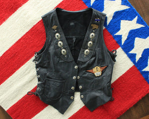 Vintage womens black leather biker vest with patches and pins, size small