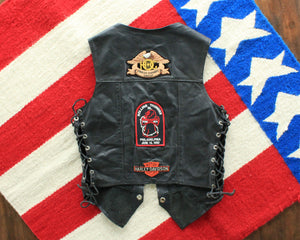 Vintage womens black leather biker vest with patches and pins, size small